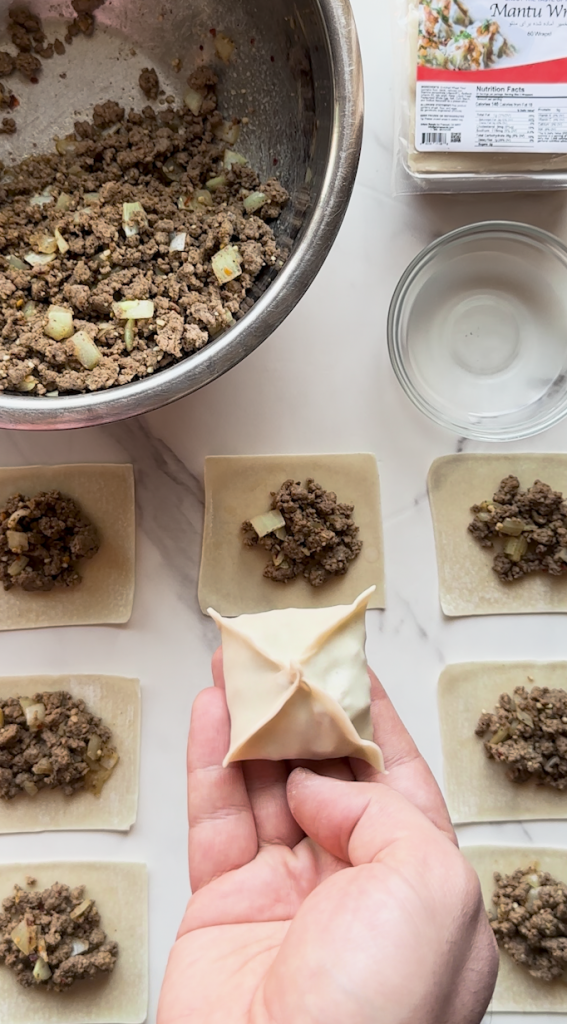 mantu being prepped with dumpling wraps from Ariana sweets